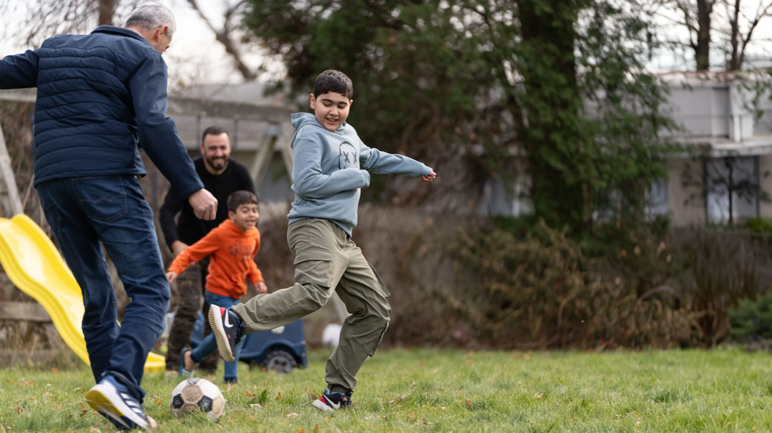 Heart-transplant patient playing soccer with his family.